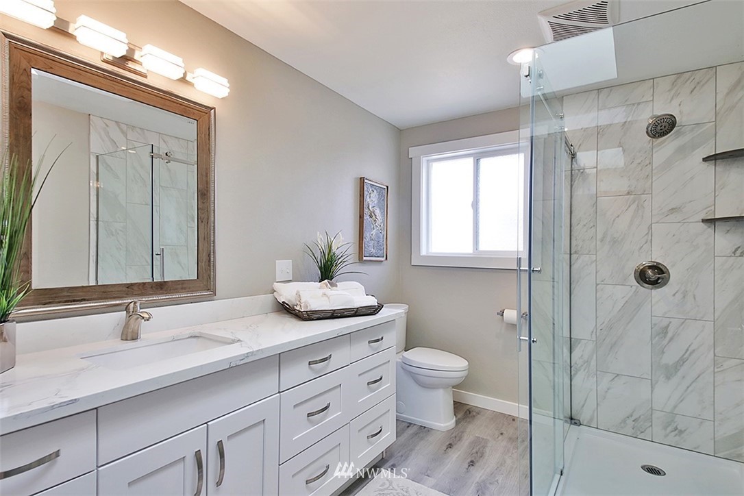971 Sandy Point Road Langley, WA 98260 - Photo 12 of 25 a bathroom with a granite countertop sink toilet and shower