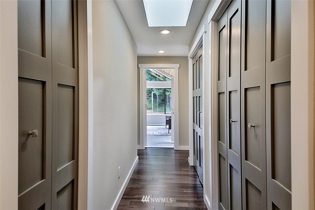 971 Sandy Point Road Langley, WA 98260 - Photo 13 of 25 a view of a hallway with wooden floor and a glass door