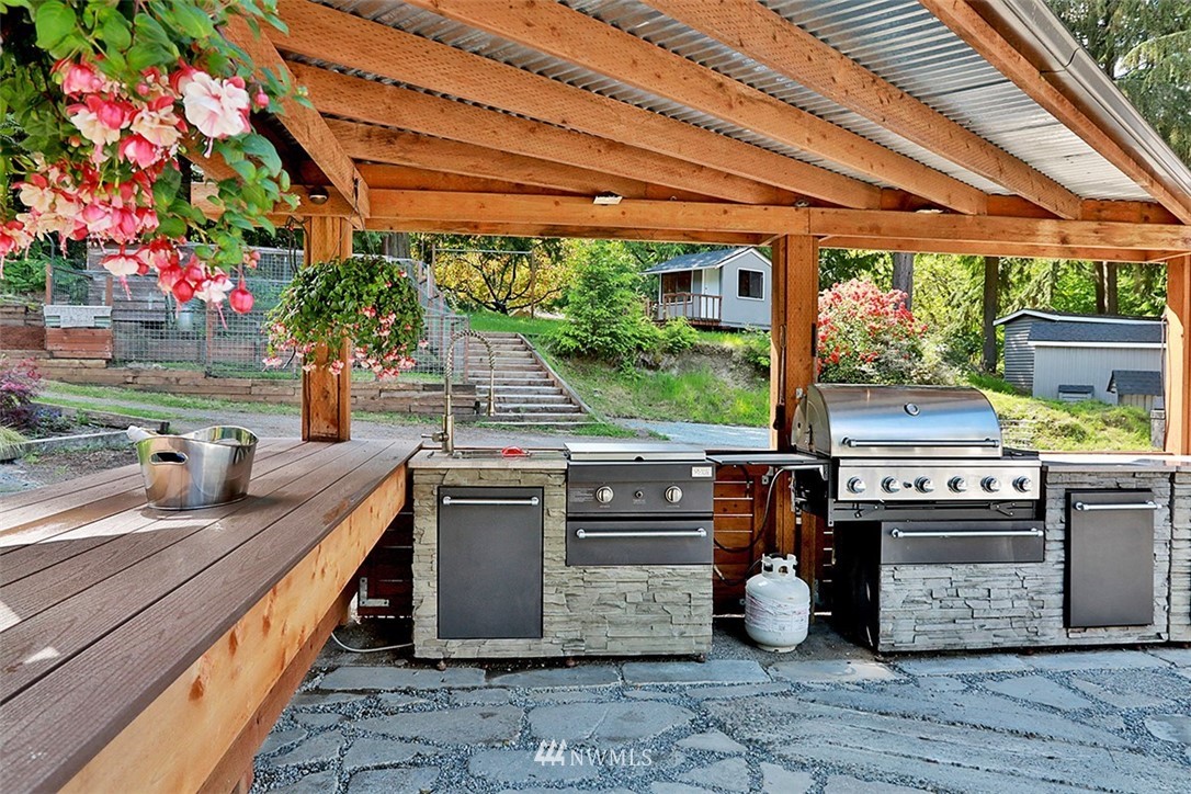 971 Sandy Point Road Langley, WA 98260 - Photo 19 of 25 a kitchen with stainless steel appliances granite countertop a stove a sink and a microwave