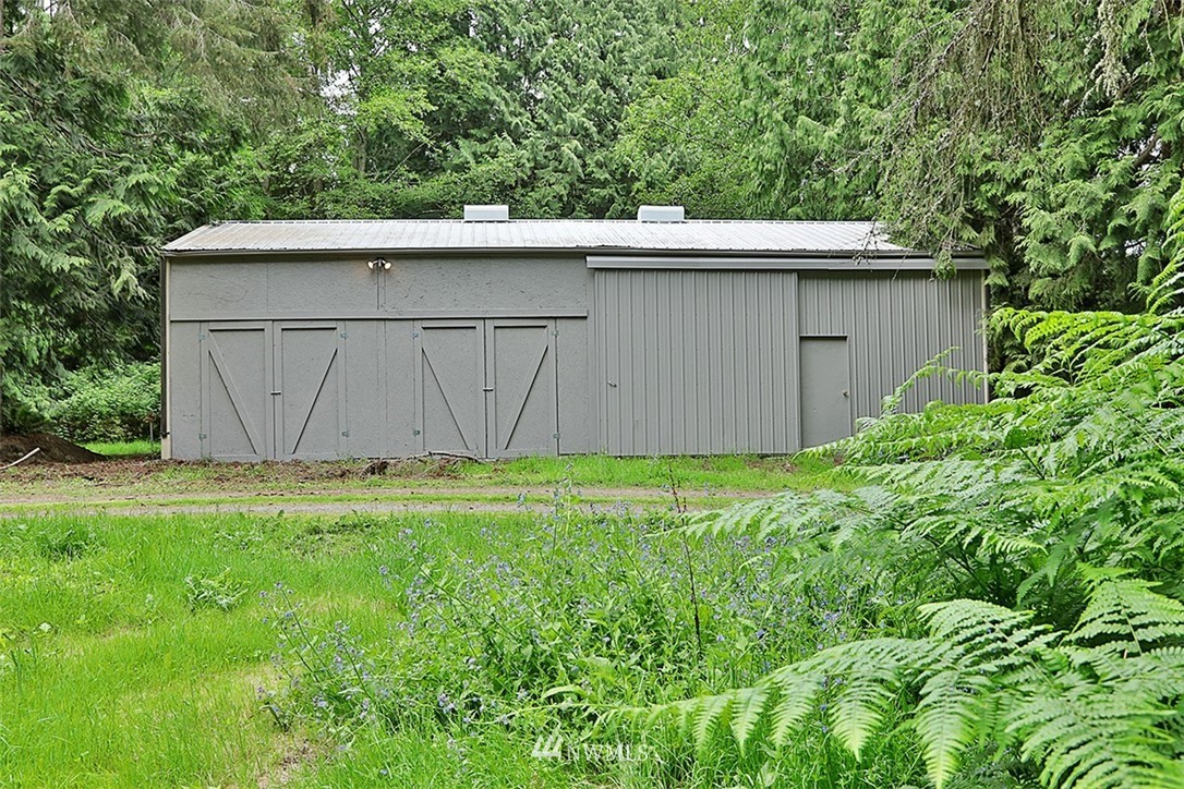971 Sandy Point Road Langley, WA 98260 - Photo 22 of 25 a backyard of a house with lots of green space and plants