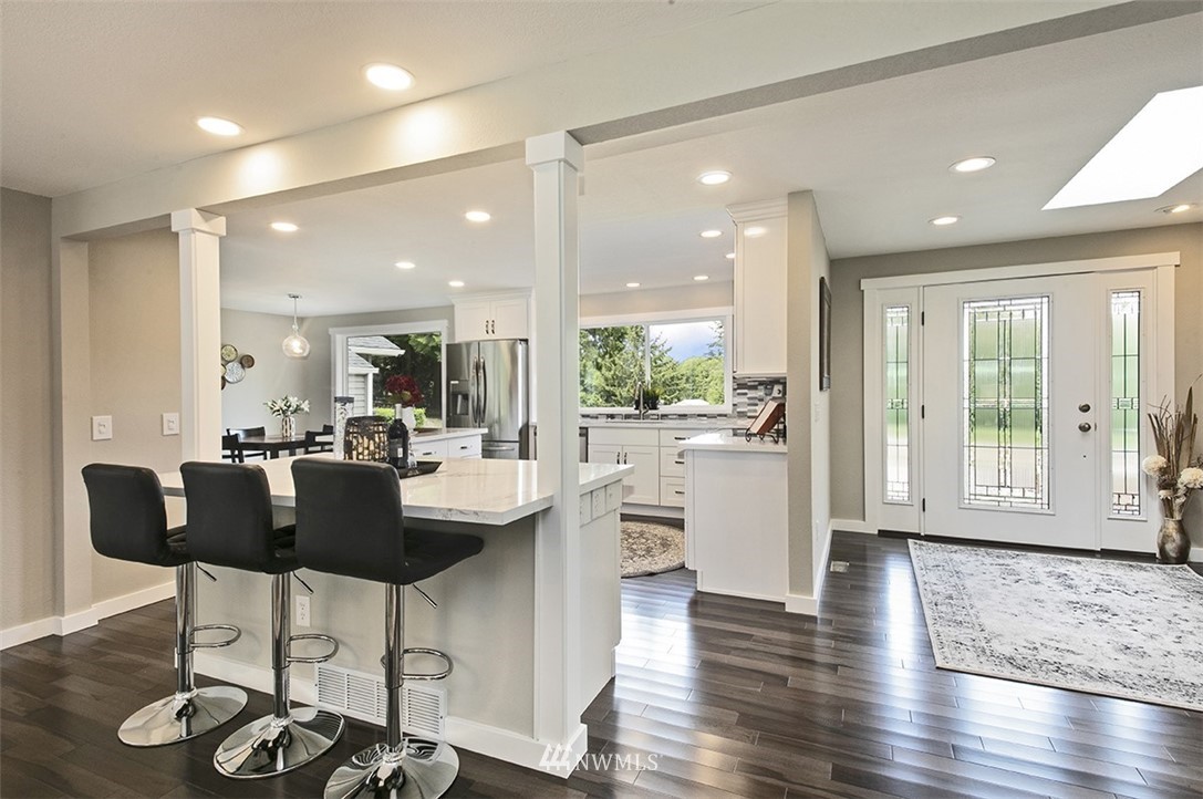 971 Sandy Point Road Langley, WA 98260 - Photo 4 of 25 a kitchen with stainless steel appliances kitchen island granite countertop a table and chairs in it