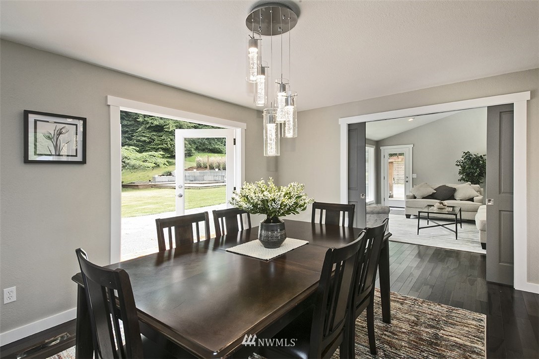 971 Sandy Point Road Langley, WA 98260 - Photo 10 of 25 a view of a dining room with furniture window and wooden floor