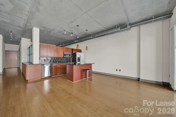 a kitchen with granite countertop a stove and a refrigerator