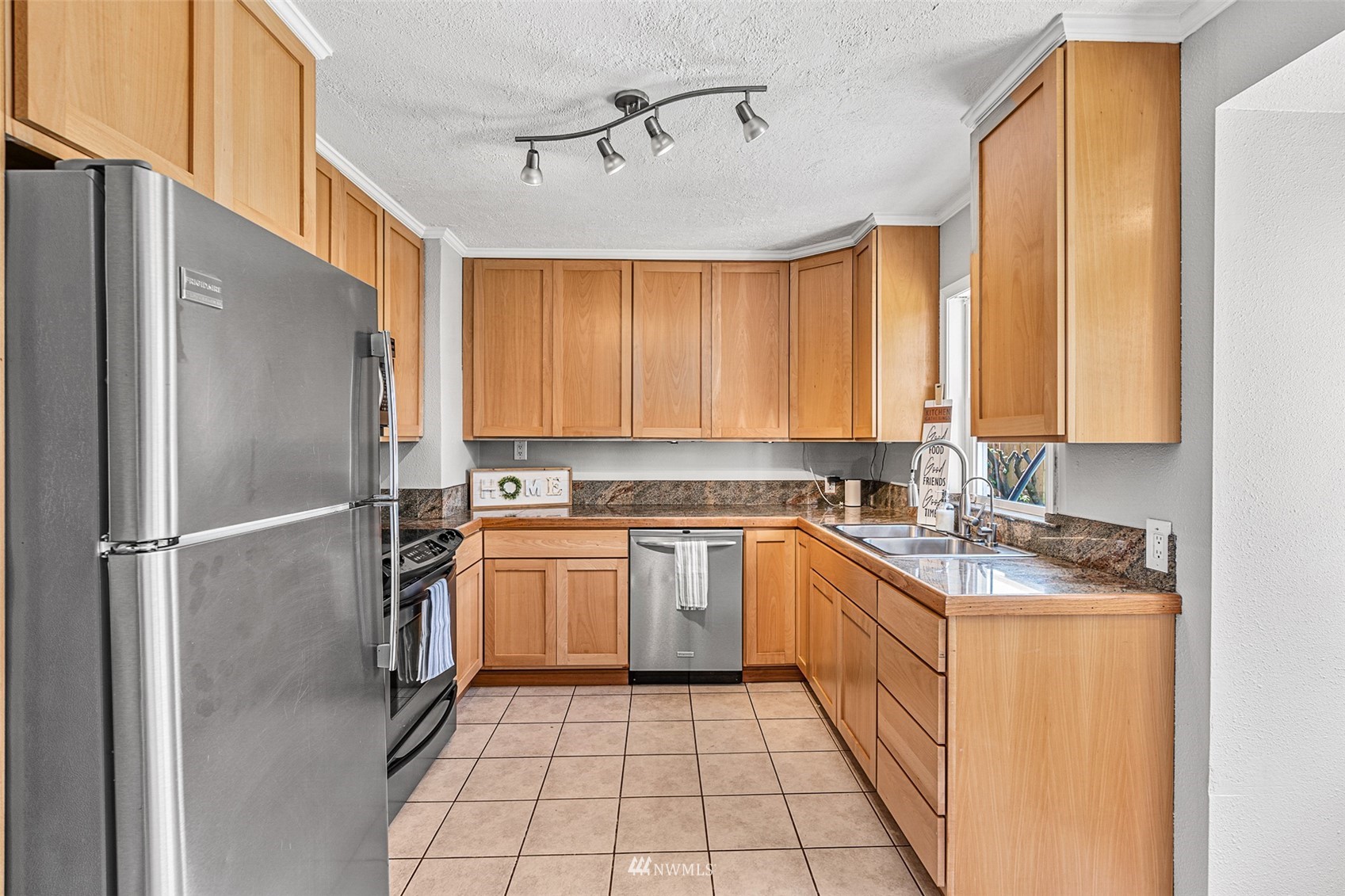 1818 Maple Street Everett, WA 98201 - Photo 12 of 37 a kitchen with stainless steel appliances granite countertop a sink stove and refrigerator