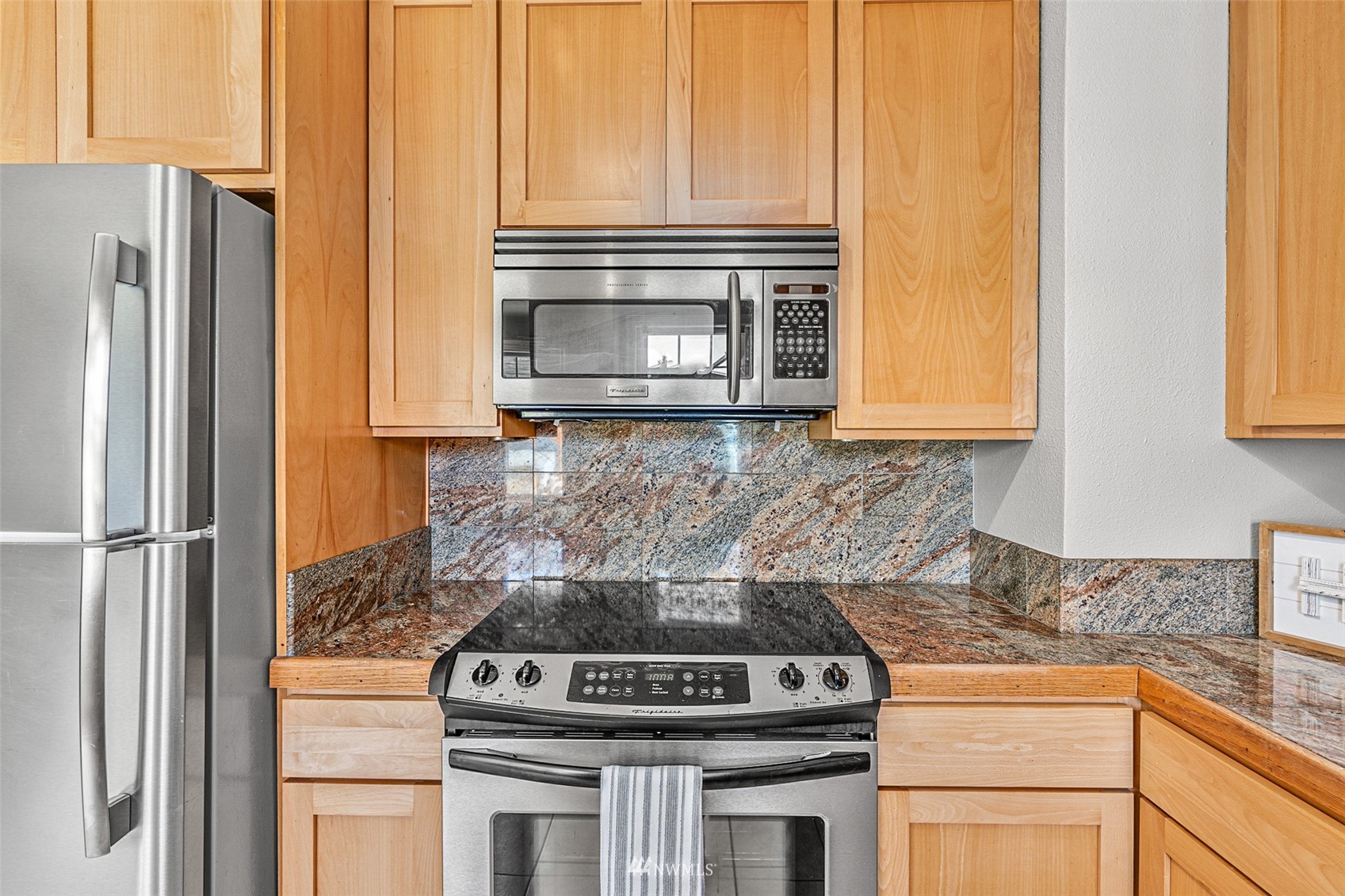 1818 Maple Street Everett, WA 98201 - Photo 13 of 37 a kitchen with a stove and a microwave