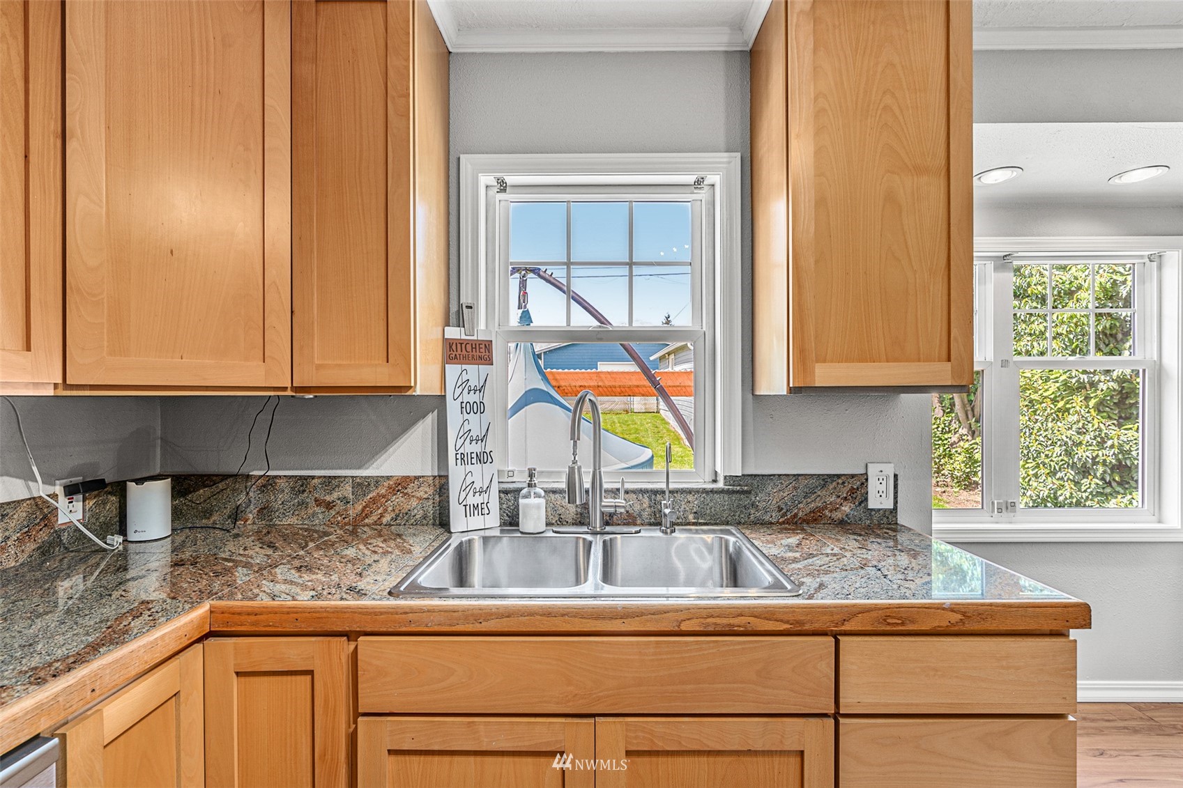1818 Maple Street Everett, WA 98201 - Photo 14 of 37 a kitchen with granite countertop a sink a window and cabinets