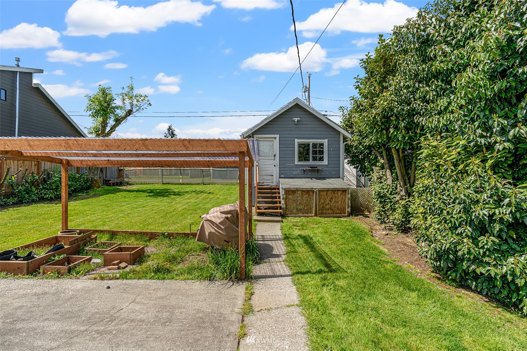 1818 Maple Street Everett, WA 98201 - Photo 19 of 37 a view of a house with backyard and a tree
