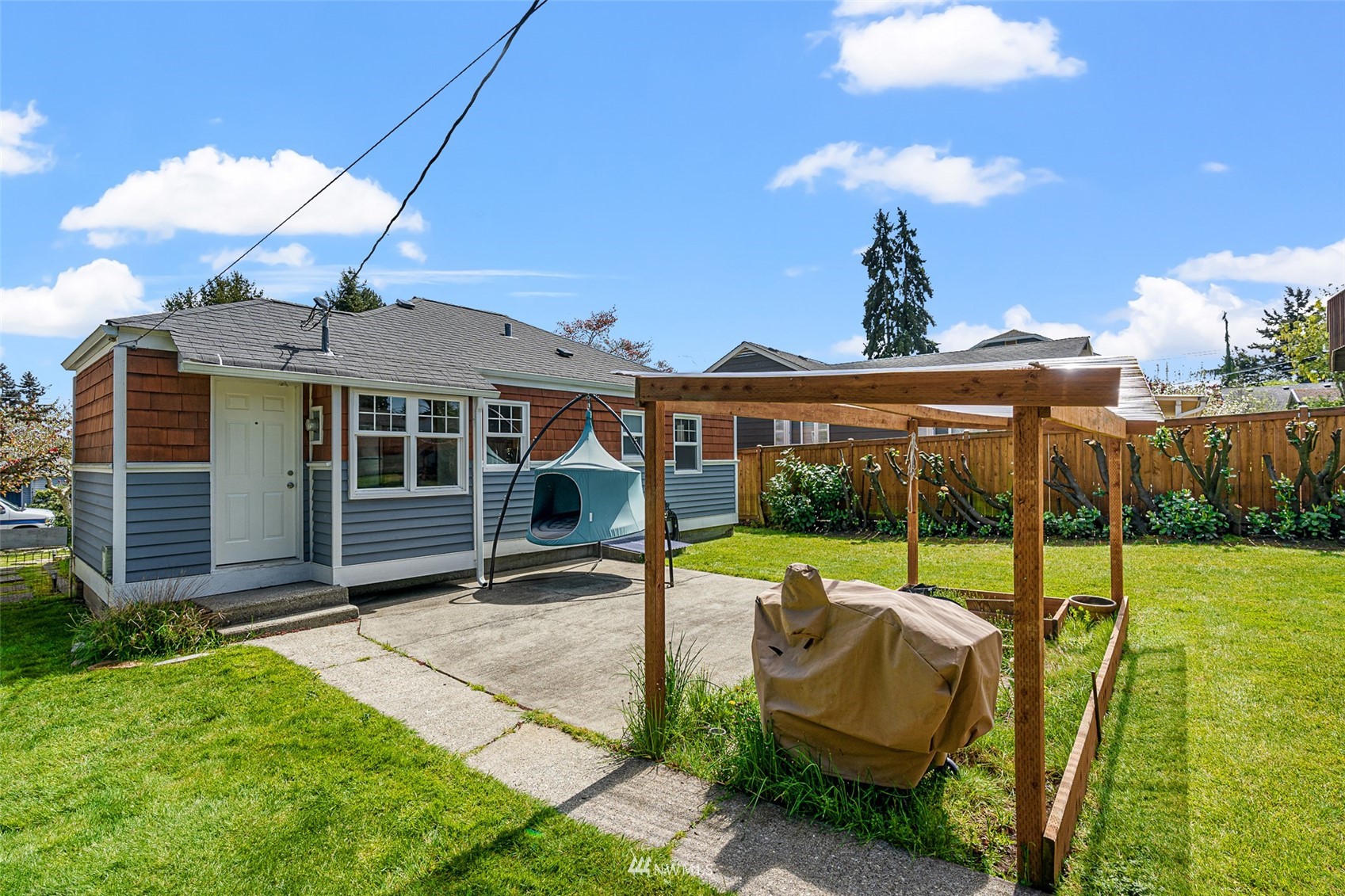 1818 Maple Street Everett, WA 98201 - Photo 20 of 37 a view of a house with backyard and a patio