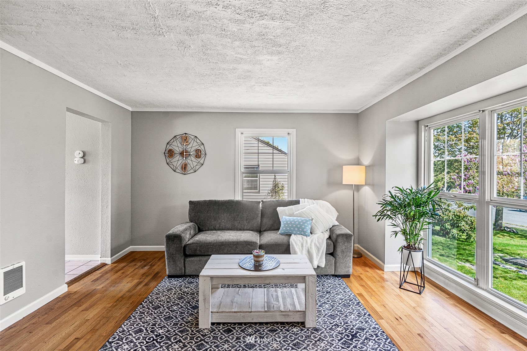 1818 Maple Street Everett, WA 98201 - Photo 5 of 37 a living room with furniture and a large window with garden view