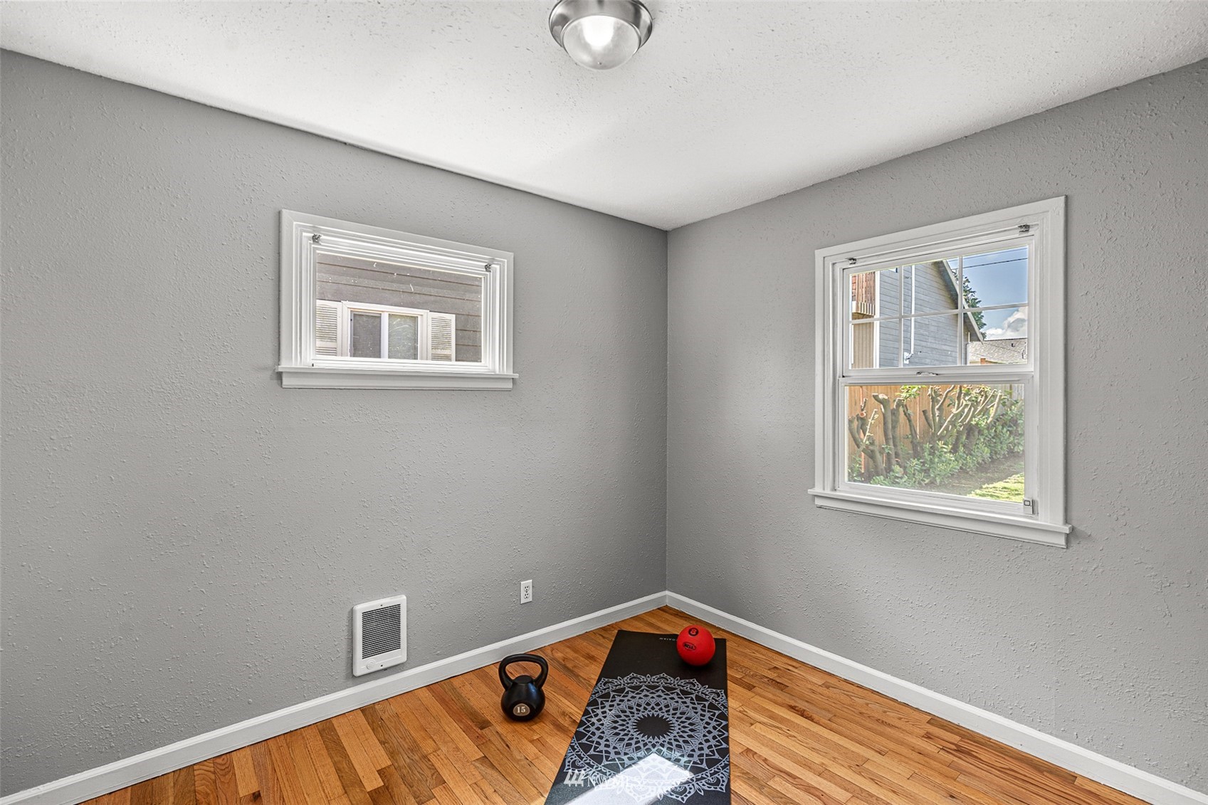 1818 Maple Street Everett, WA 98201 - Photo 10 of 37 a room with window and a wooden floor