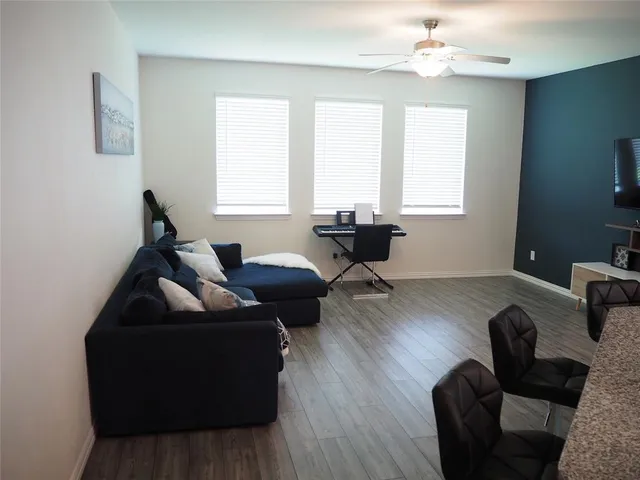 a living room with furniture and wooden floor