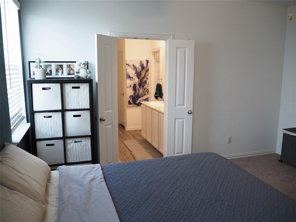 1116 Mesquite Lane Princeton, TX 75407 - Photo 13 of 28 a bedroom with a bed and wooden floor