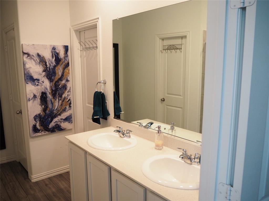 1116 Mesquite Lane Princeton, TX 75407 - Photo 14 of 28 a bathroom with a sink and a mirror