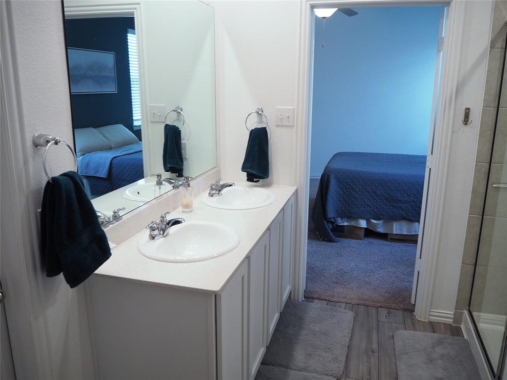 1116 Mesquite Lane Princeton, TX 75407 - Photo 15 of 28 a bathroom with a sink vanity and a mirror