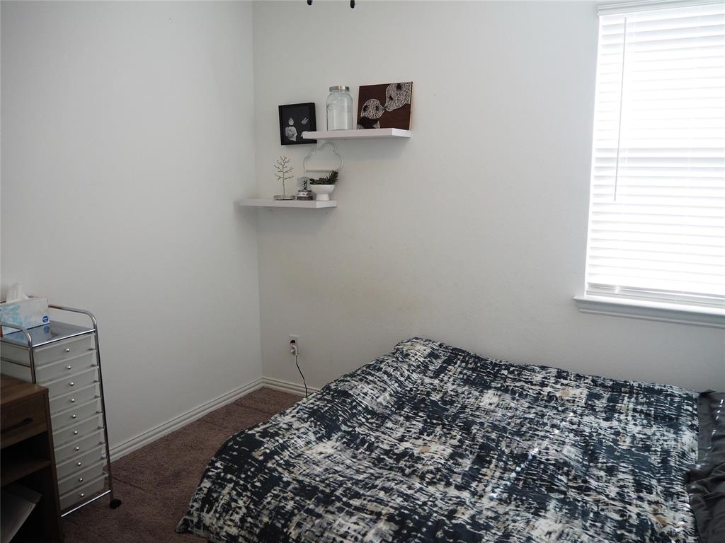 1116 Mesquite Lane Princeton, TX 75407 - Photo 20 of 28 a bedroom with a bed and a tv