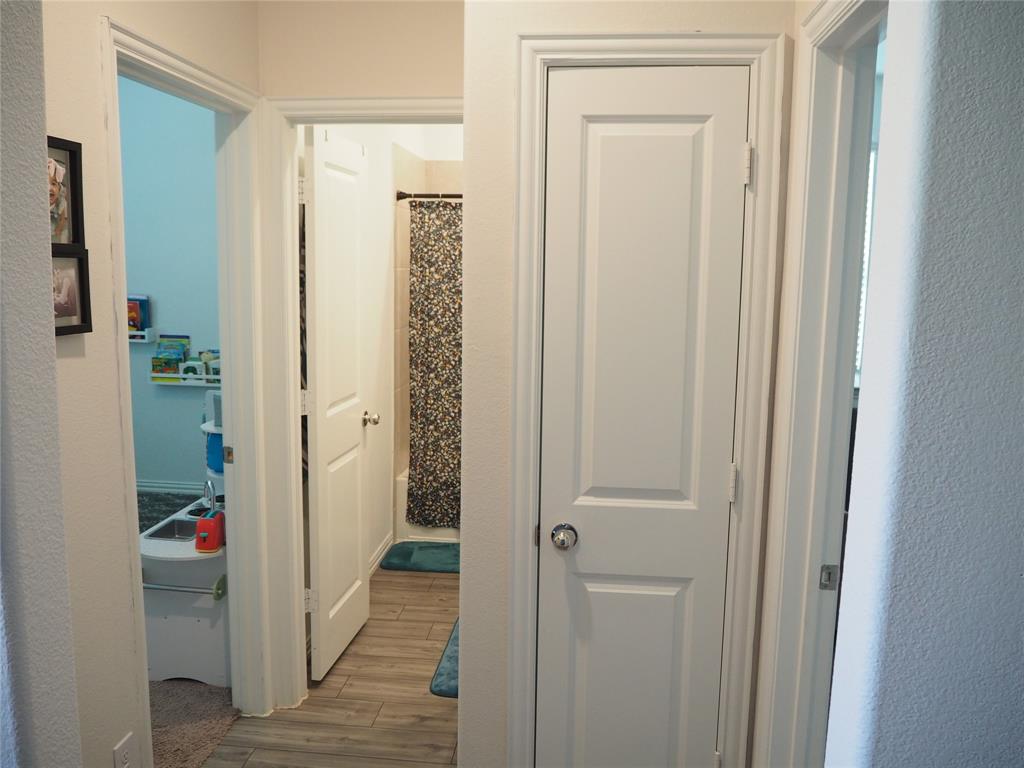 1116 Mesquite Lane Princeton, TX 75407 - Photo 22 of 28 a view of a hallway with wooden shelves