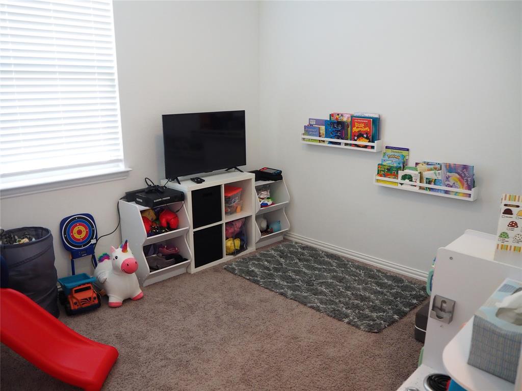 1116 Mesquite Lane Princeton, TX 75407 - Photo 24 of 28 a room with toys and a flat screen tv