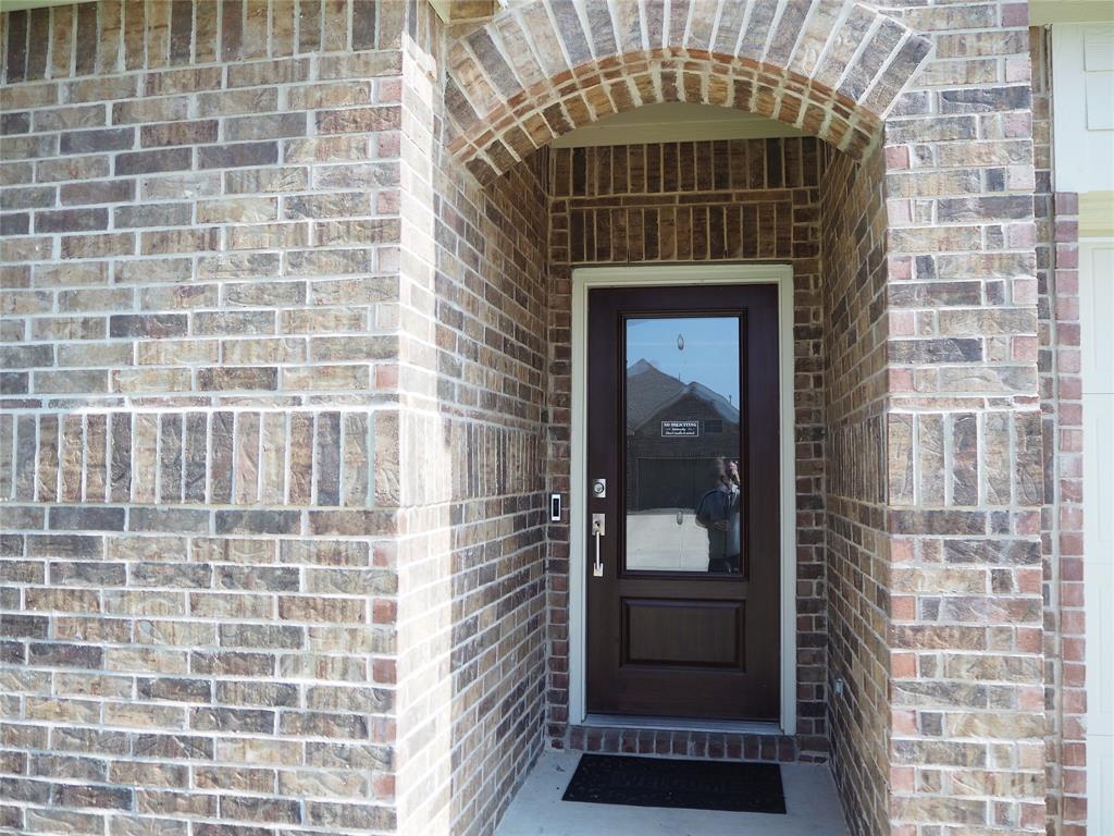 1116 Mesquite Lane Princeton, TX 75407 - Photo 3 of 28 a front view of a house with a glass door