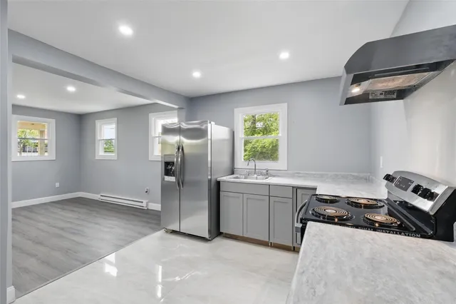 a kitchen with a refrigerator and a stove top oven