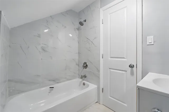 a bathroom with a bathtub and a sink