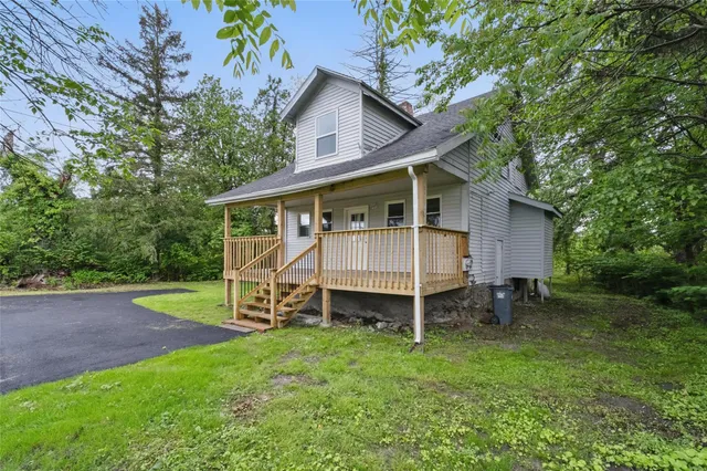 a view of a house with a yard and sitting area