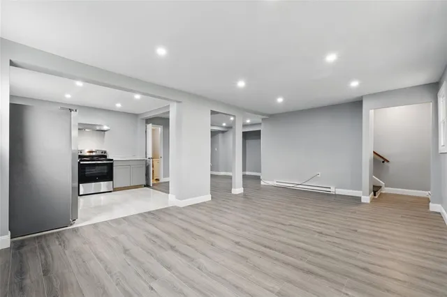 a view of empty room with wooden floor