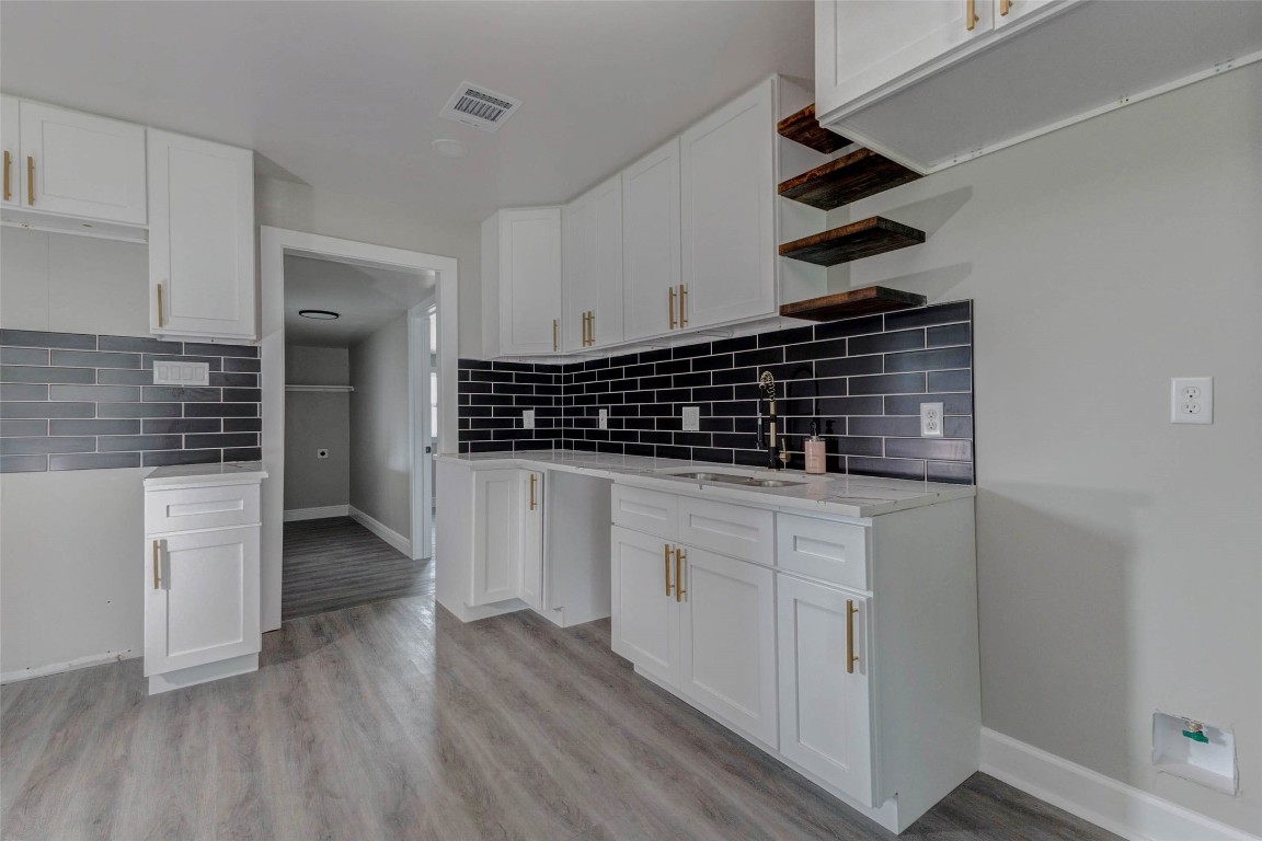 511 Wagers Street Conroe, TX 77301 - Photo 12 of 39 a kitchen with white cabinets and a stove