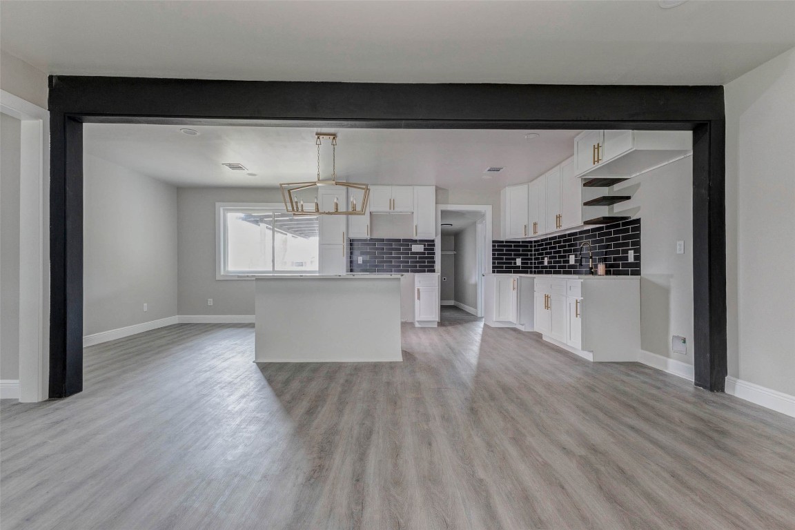 511 Wagers Street Conroe, TX 77301 - Photo 13 of 39 a view of a kitchen with wooden floor and electronic appliances