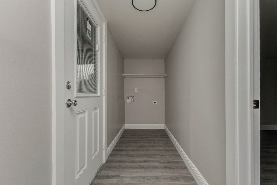 511 Wagers Street Conroe, TX 77301 - Photo 14 of 39 a view of a hallway with wooden floor and glass door