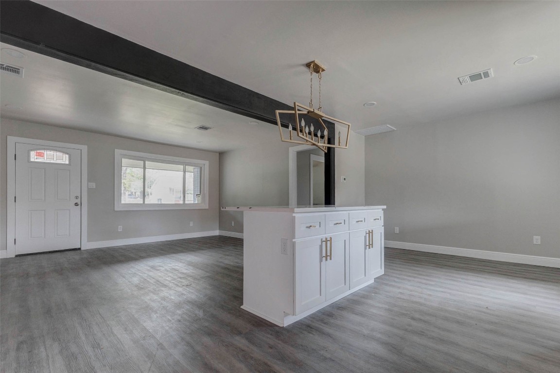 511 Wagers Street Conroe, TX 77301 - Photo 17 of 39 a hallway with white cabinets and wooden floor
