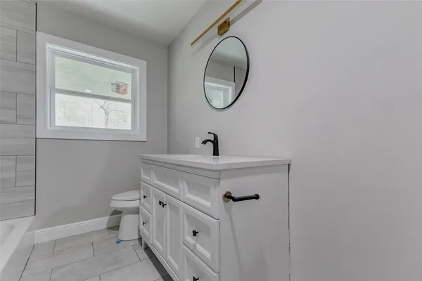 a bathroom with a sink and mirror