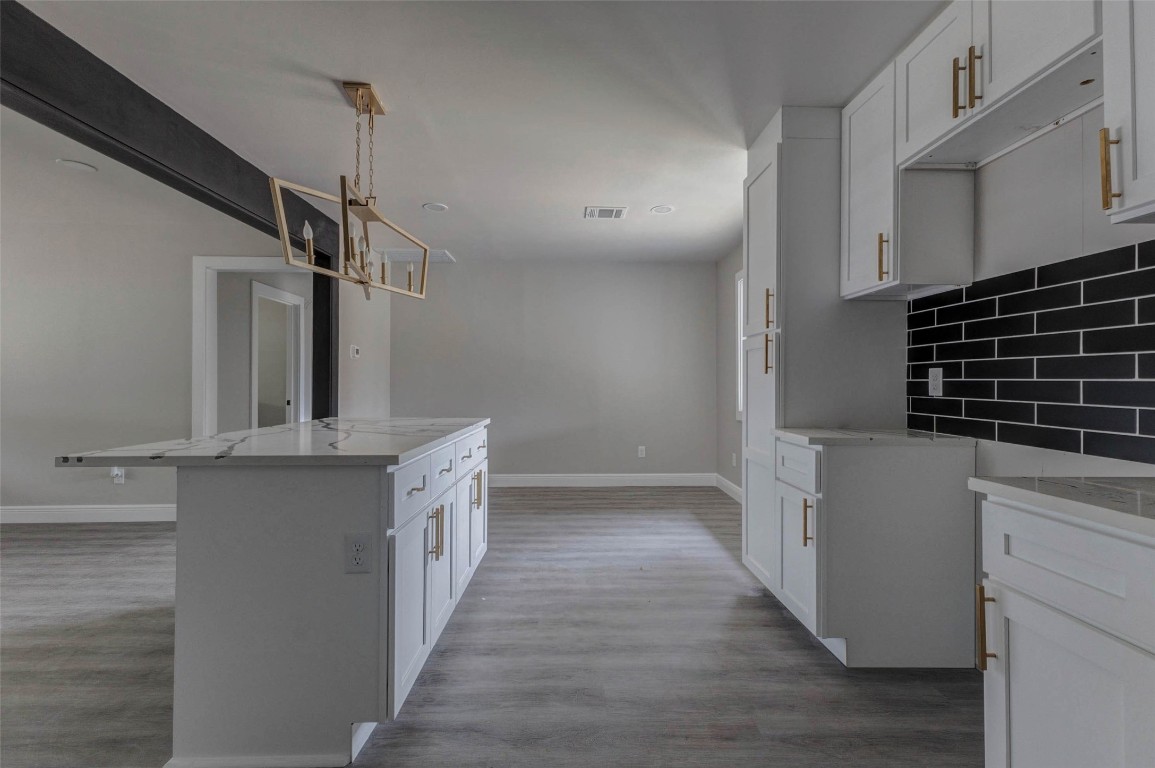 511 Wagers Street Conroe, TX 77301 - Photo 32 of 39 a kitchen with cabinets and wooden floor