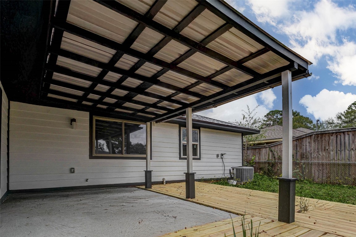 511 Wagers Street Conroe, TX 77301 - Photo 37 of 39 a view of backyard with small cabin and wooden fencing