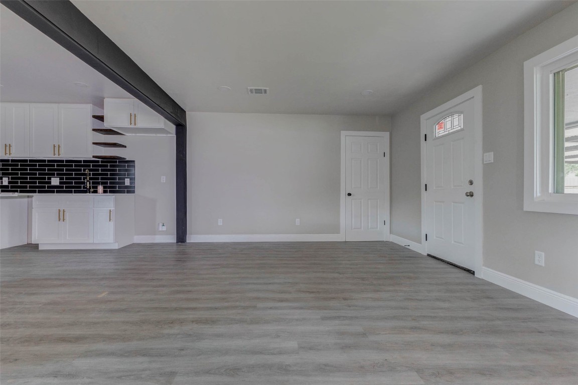 511 Wagers Street Conroe, TX 77301 - Photo 7 of 39 a view of an empty room with wooden floor and a window