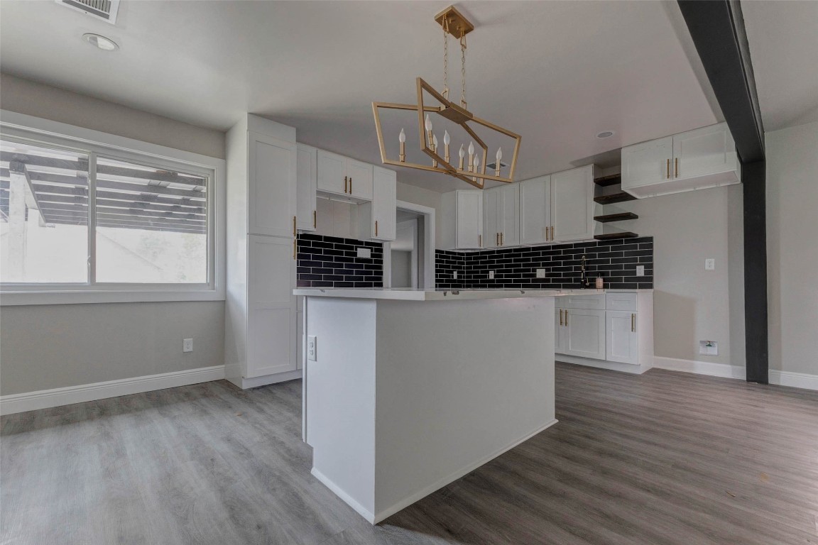 511 Wagers Street Conroe, TX 77301 - Photo 8 of 39 a kitchen with stainless steel appliances kitchen island granite countertop a refrigerator a stove a microwave and cabinets