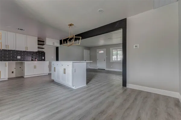 a view of a kitchen with wooden floor