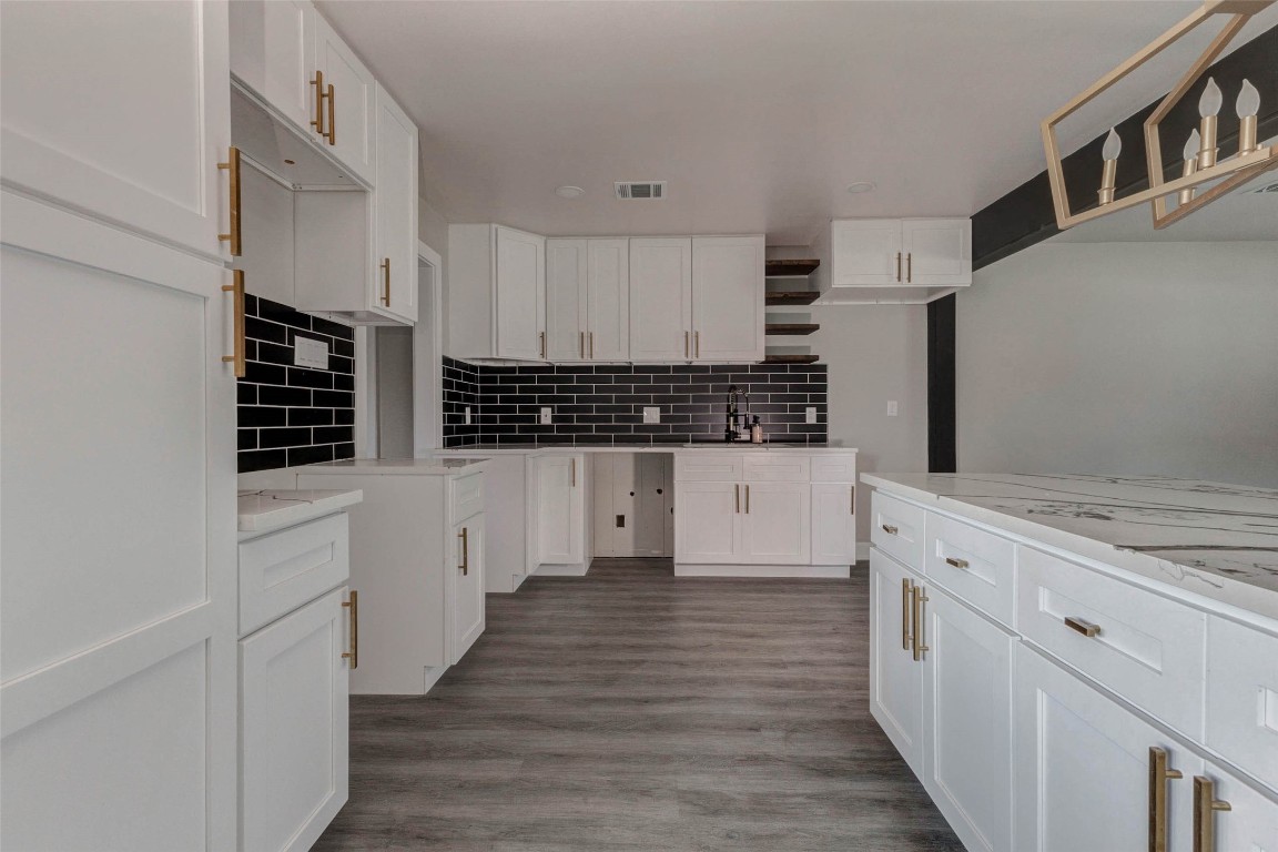 511 Wagers Street Conroe, TX 77301 - Photo 10 of 39 a kitchen with cabinets and wooden floor