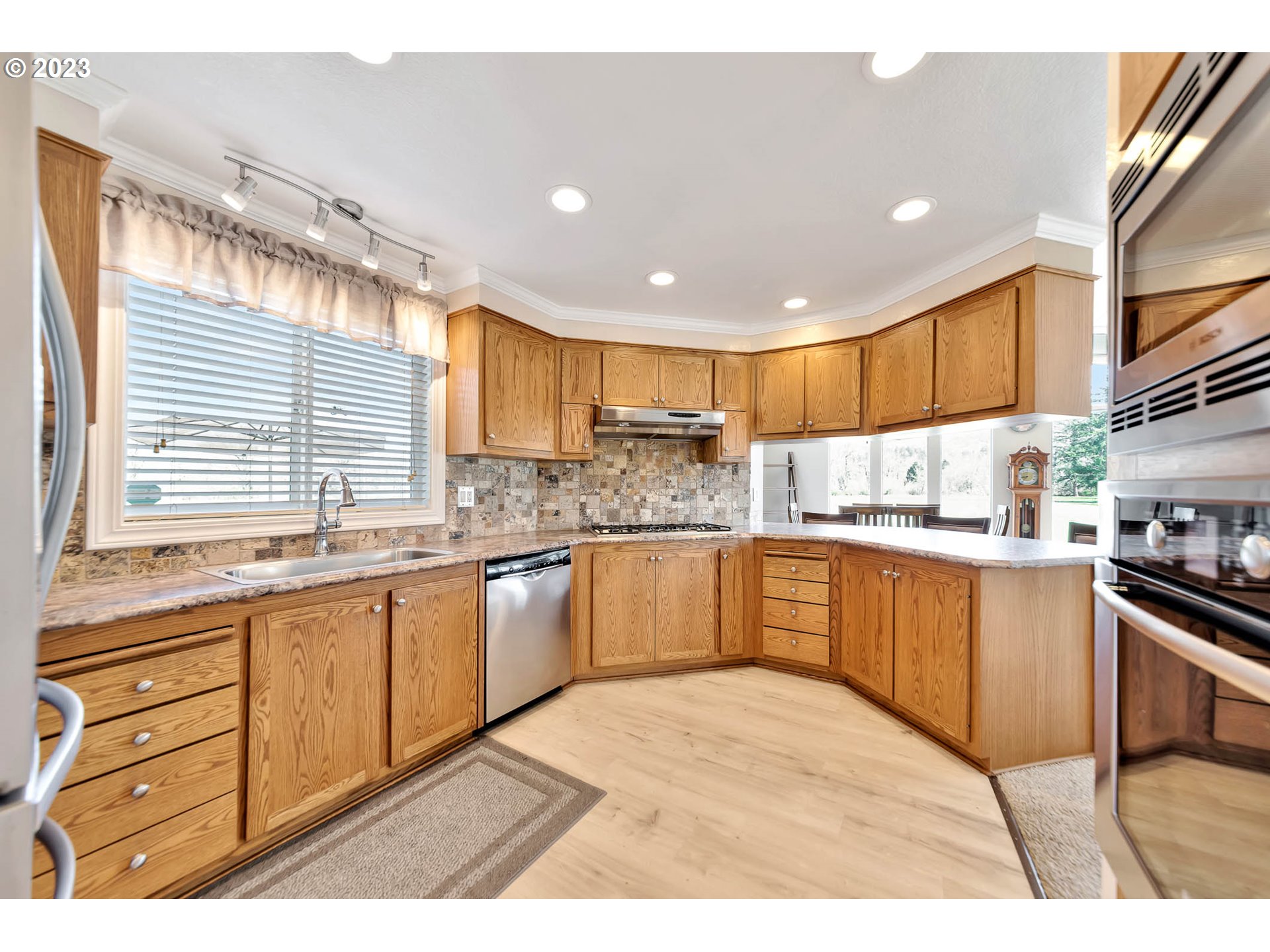 85721 Hampstead Lane Eugene, OR 97405 - Photo 15 of 45 a kitchen with stainless steel appliances granite countertop a stove sink and cabinets