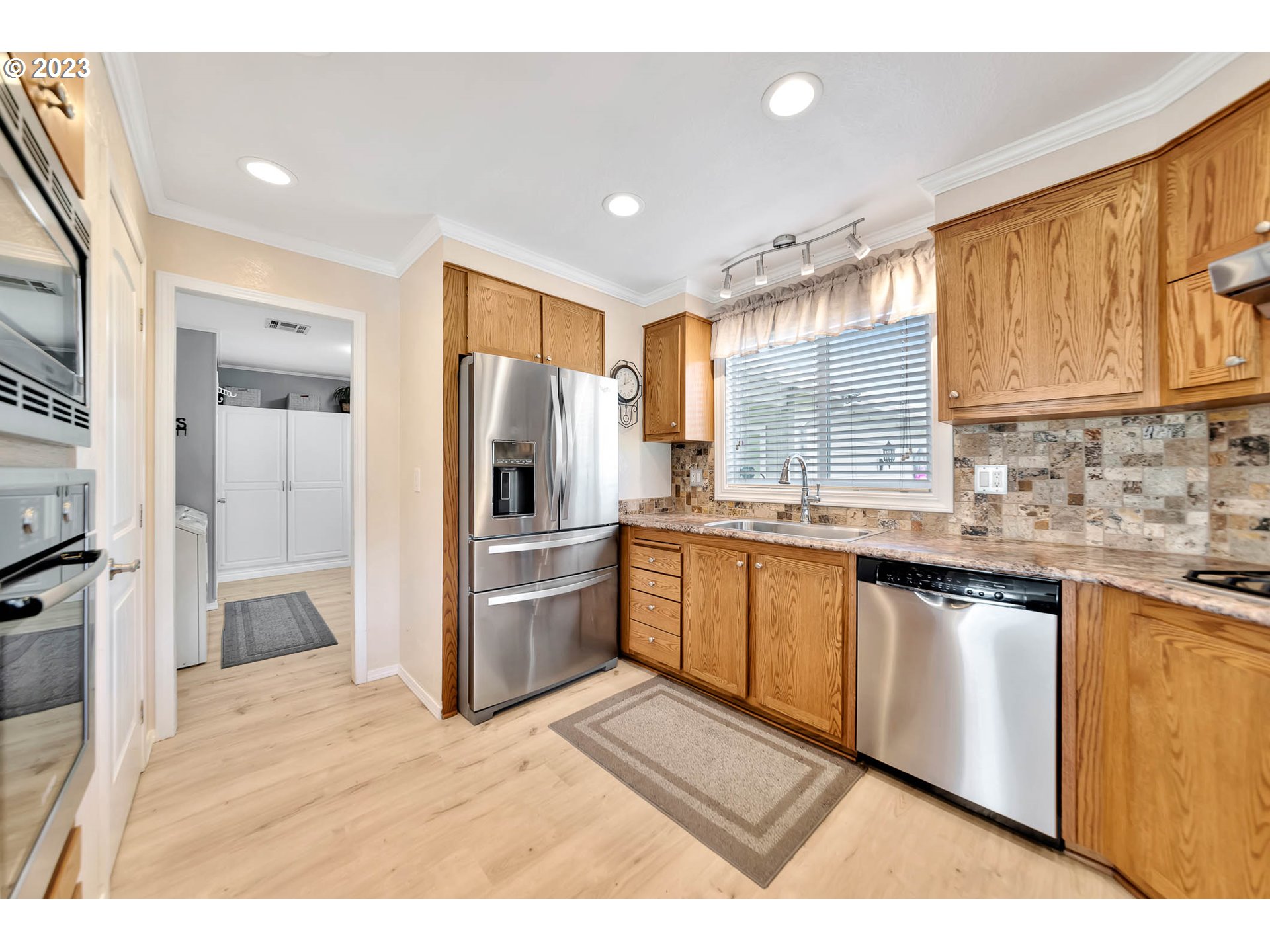 85721 Hampstead Lane Eugene, OR 97405 - Photo 16 of 45 a kitchen with granite countertop a refrigerator and cabinets