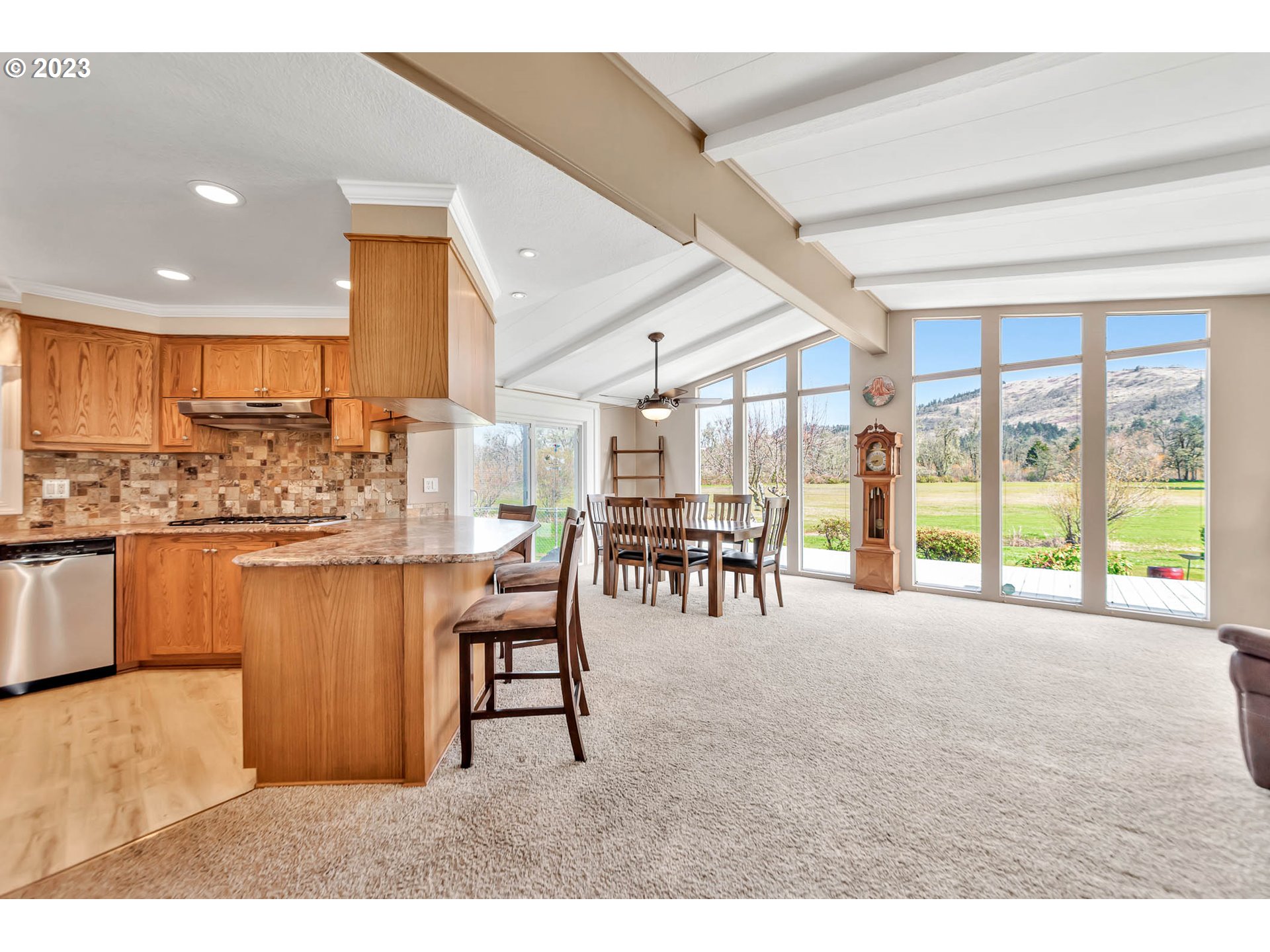 85721 Hampstead Lane Eugene, OR 97405 - Photo 19 of 45 a dining hall with stainless steel appliances kitchen island granite countertop a stove and cabinets