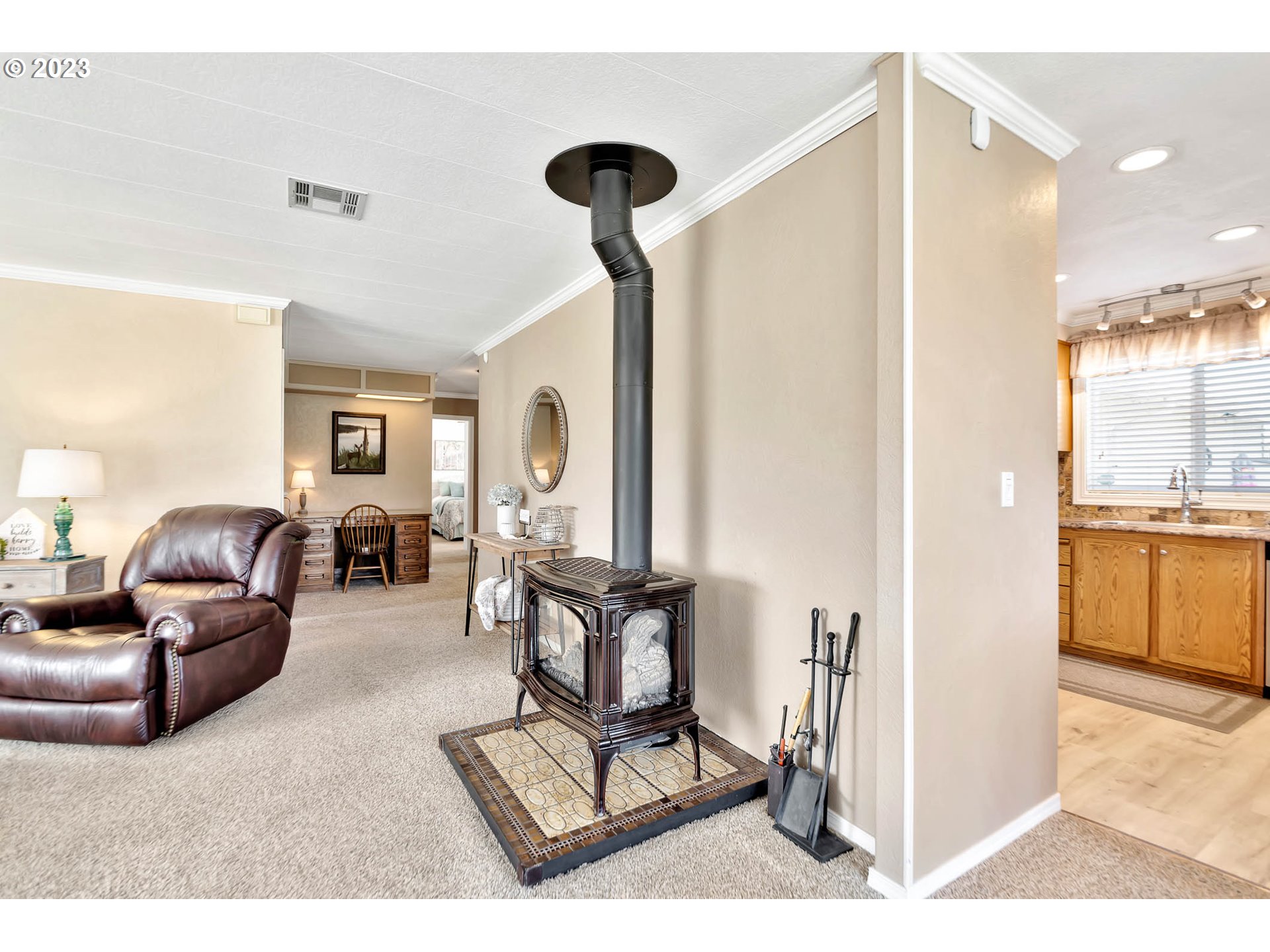 85721 Hampstead Lane Eugene, OR 97405 - Photo 25 of 45 a living room with furniture a large window and kitchen view