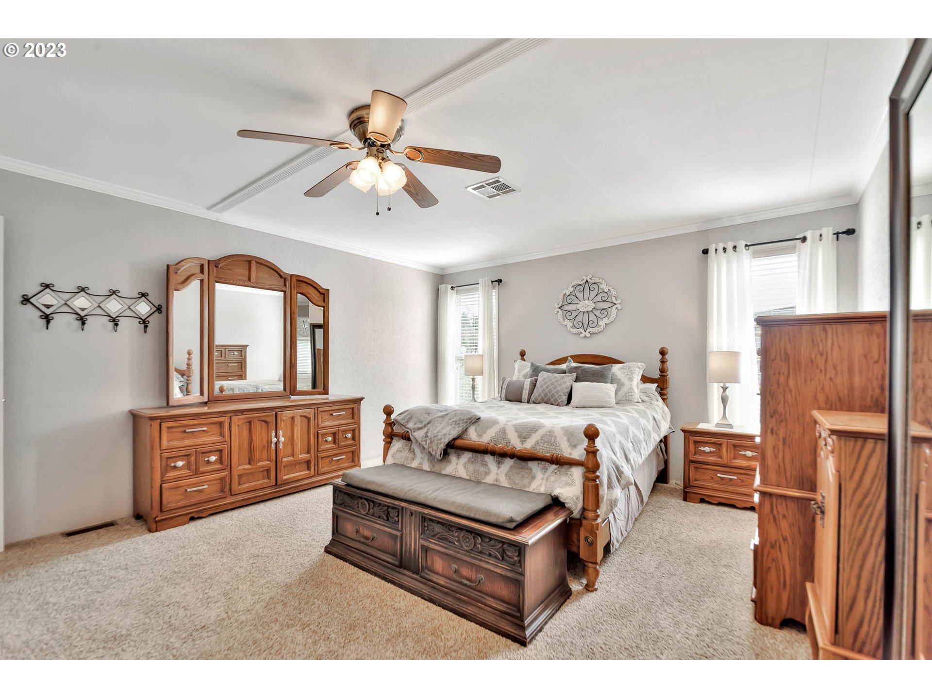 85721 Hampstead Lane Eugene, OR 97405 - Photo 27 of 45 a bedroom with a large bed and a chandelier