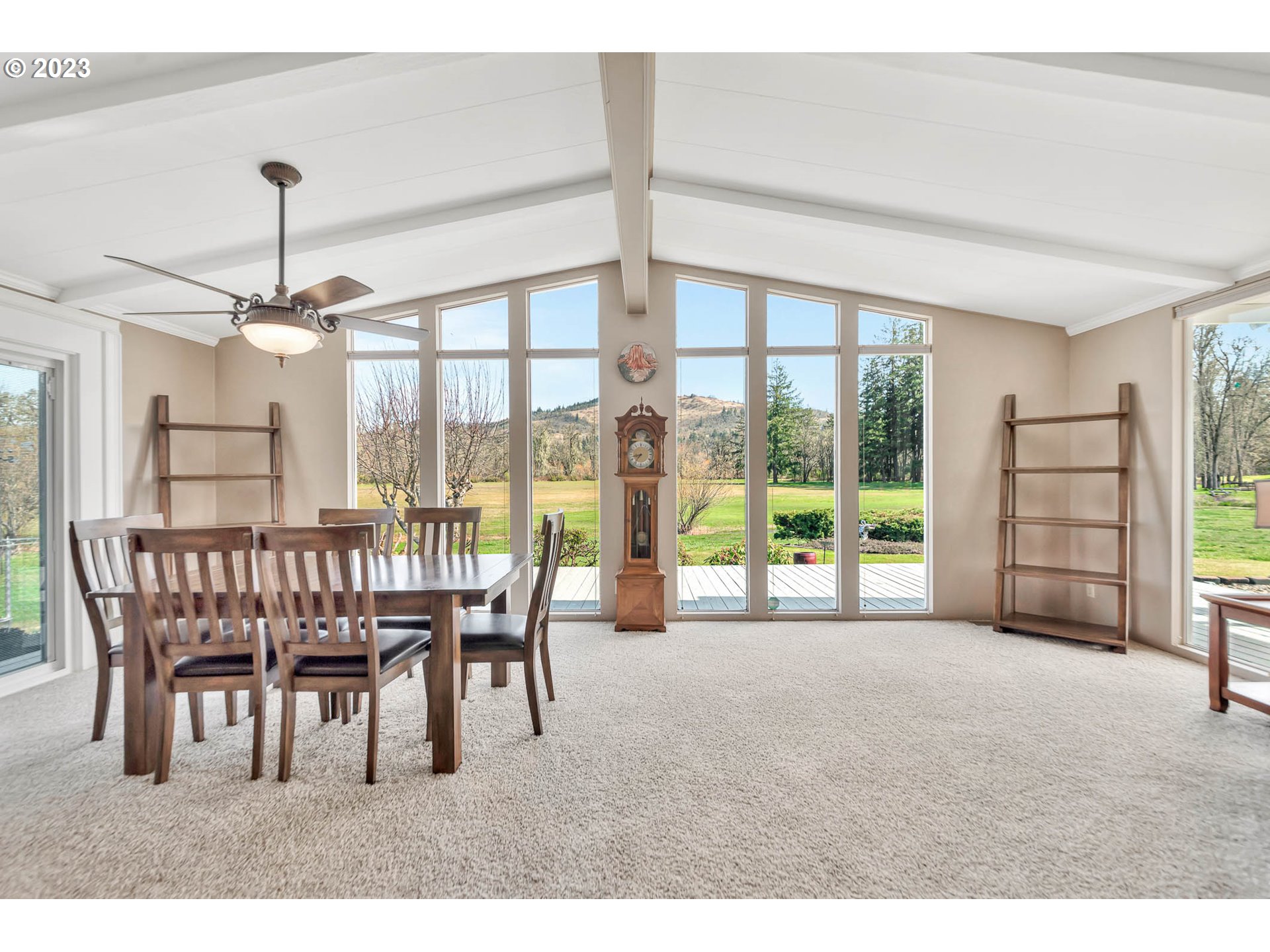 85721 Hampstead Lane Eugene, OR 97405 - Photo 7 of 45 a dining room with furniture large windows and a chandelier