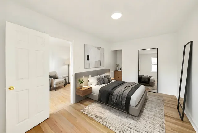 a bedroom with a bed and a mirror