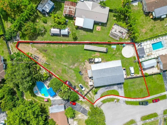 an aerial view of a house with a garden and lake view