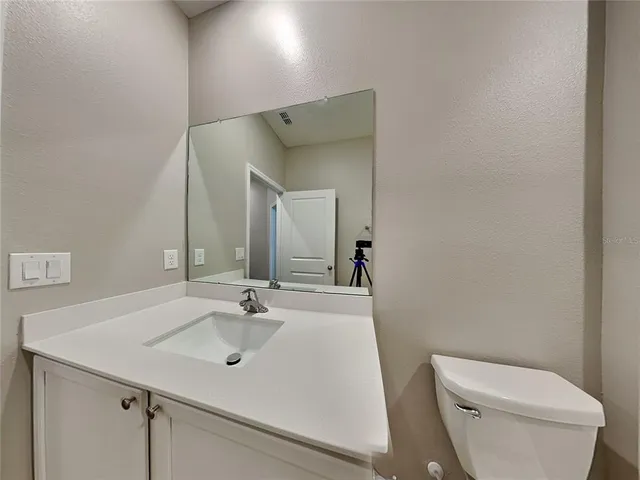 a bathroom with a sink toilet and mirror