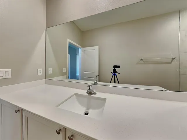 a bathroom with a sink and a mirror