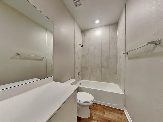 a bathroom with a toilet a sink and shower