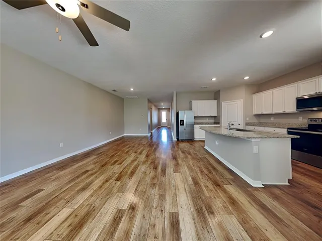 a view of kitchen with wooden floor electronic appliances and window