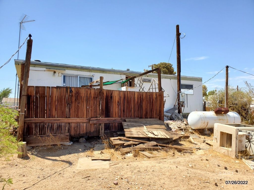 1745 West Upjohn Avenue Ridgecrest, CA 93555 - Photo 17 of 26 a view of a backyard with a wooden fence